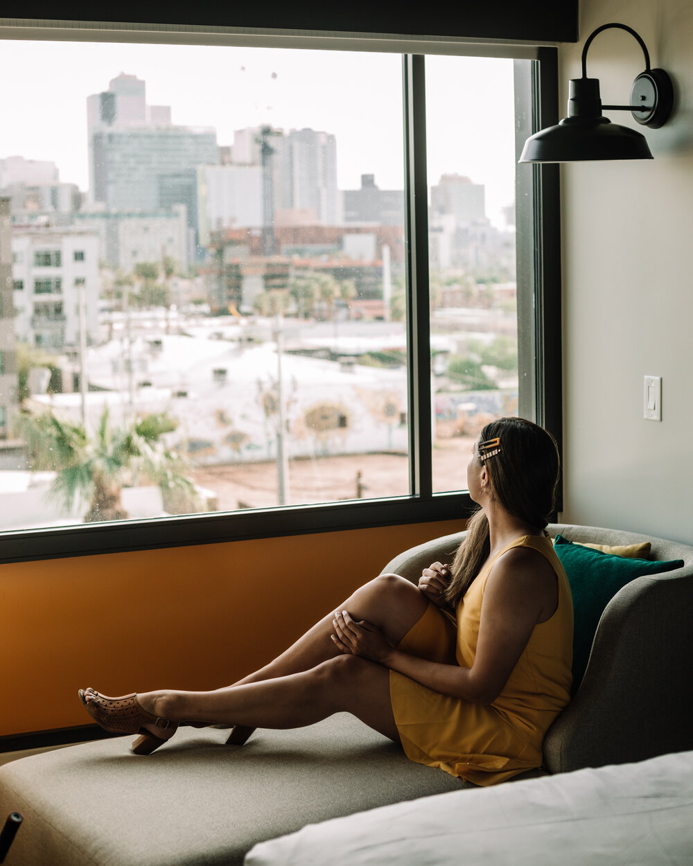 Rachel Off Duty: A Woman in a Yellow Dress Admiring the Hotel Room View