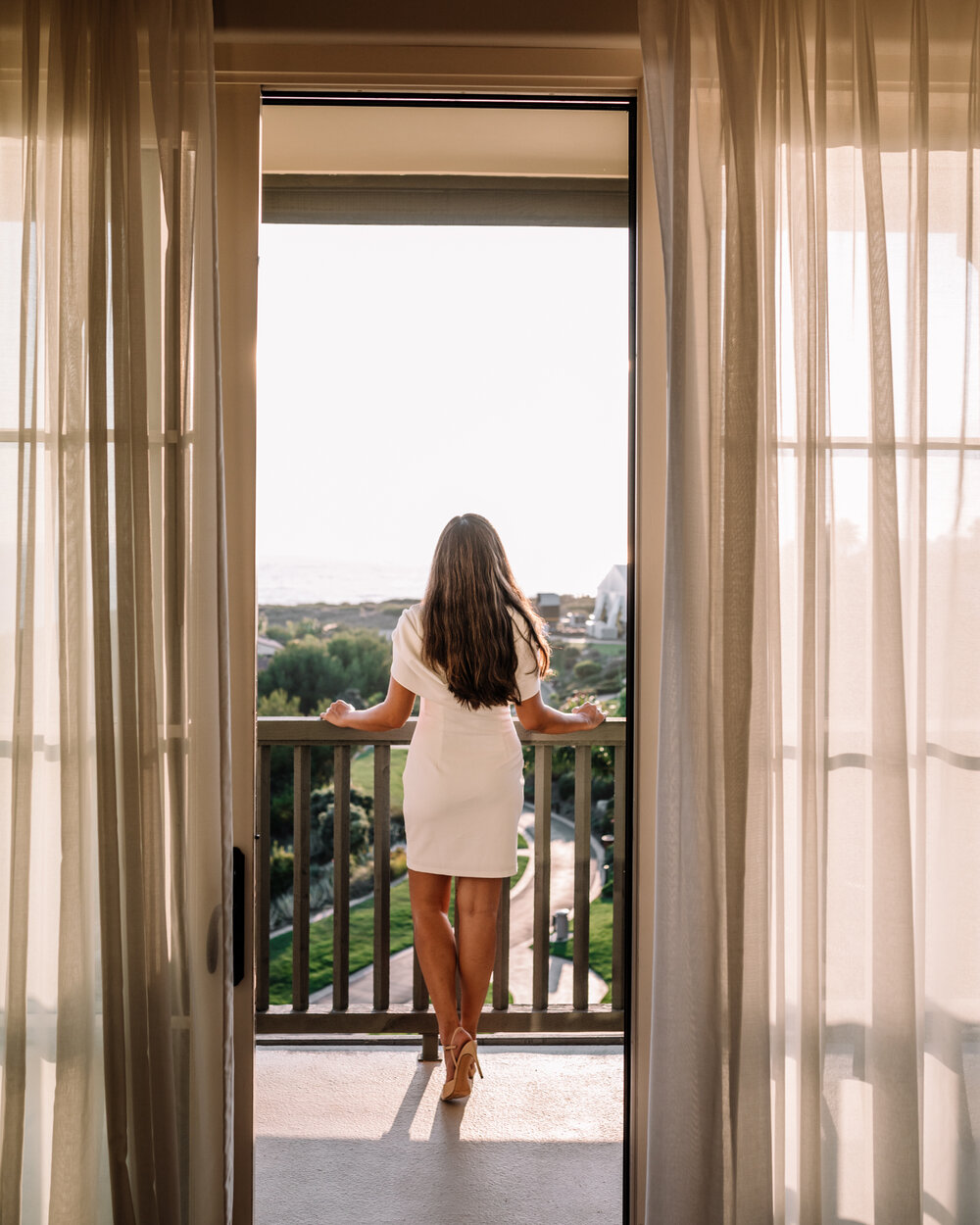 Rachel Off Duty: Woman in White Dress on Balcony at Terranea Resort