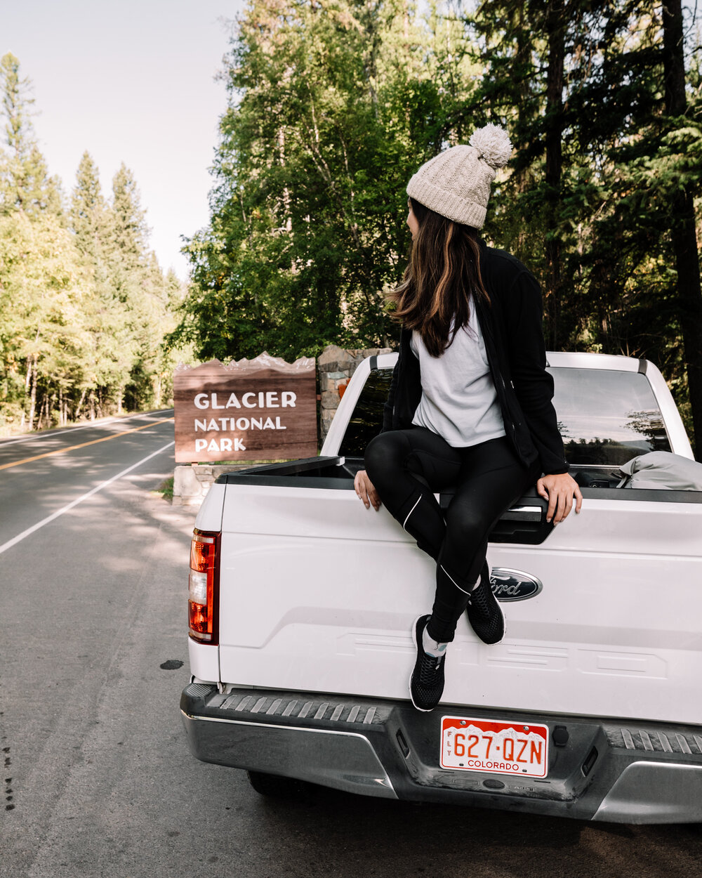 Rachel Off Duty: Woman Sitting on a Truck in Glacier National Park