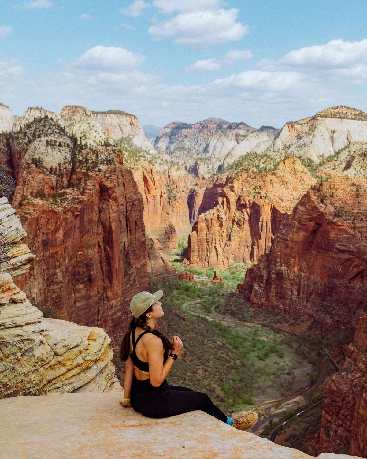 Rachel Off Duty: A Woman Sits on the Edge of the Angel's Landing in Zion National Park
